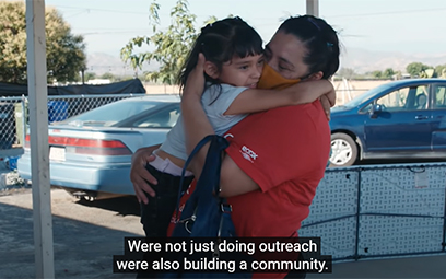 Frame from the Inside a door-to-door vaccine education campaign video