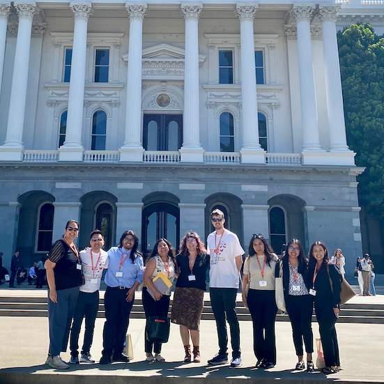 Group of people standing in front of the California State Capitol
