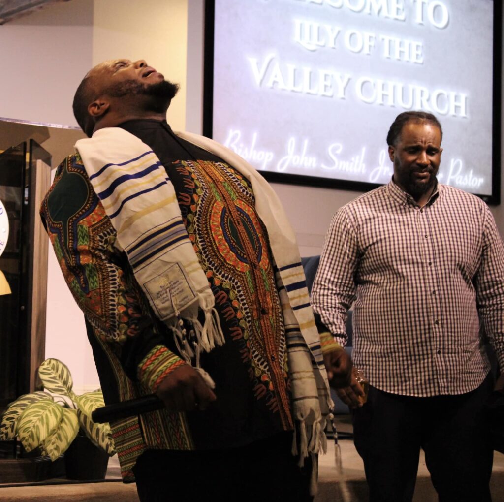 Man in ceremonial garb at Lily of the Valley Emmanuel Church of Jesus Christ