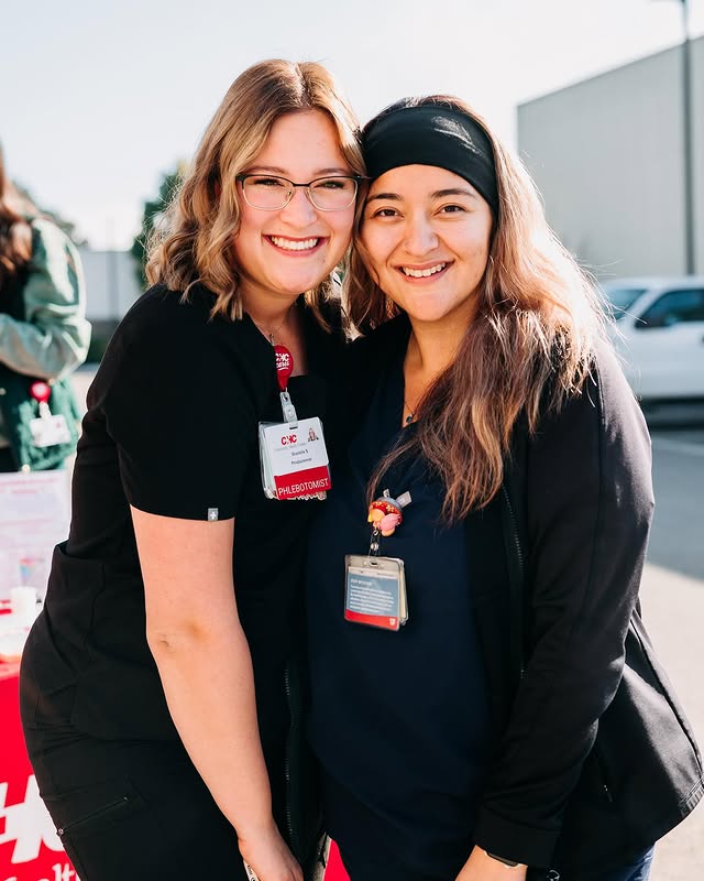 Two healthcare workers smiling for the camera