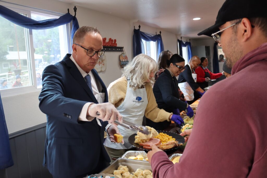 People from Social Model Recovery Systems serving food