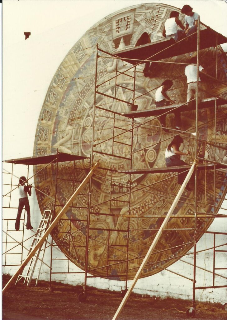 People on scaffolding creating a piece of art