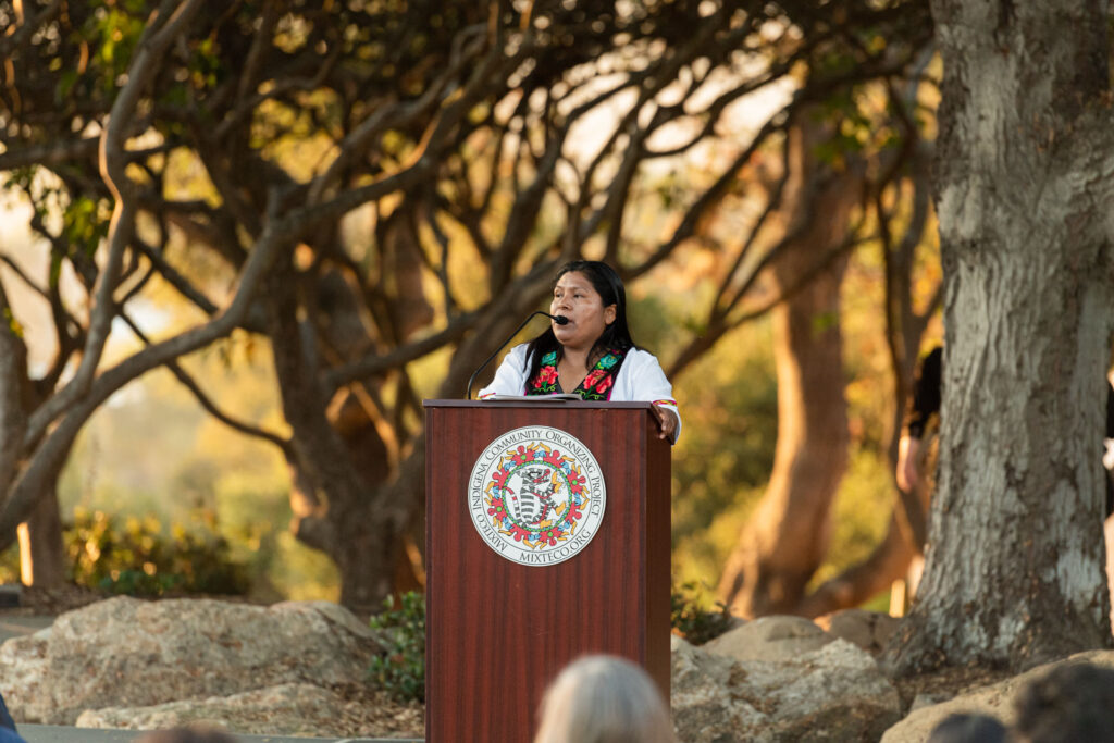 Woman making speech at Mixteco Indigena Community Organizing Project event