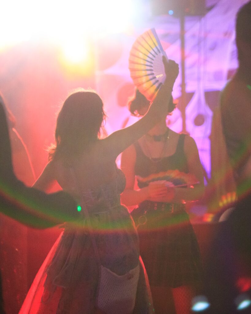 Woman in dress with rainbow fan at Sacramento LGBT Community Center event