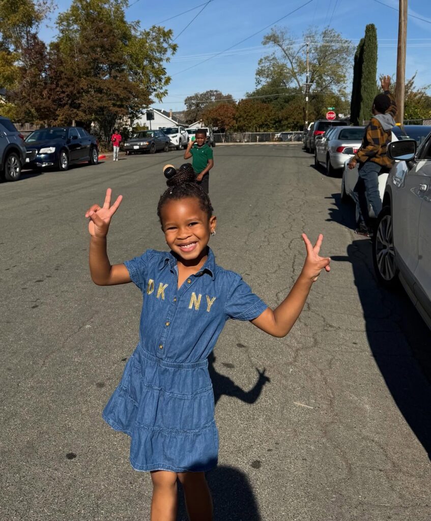 African-American girl posing for the camera while walking in the street