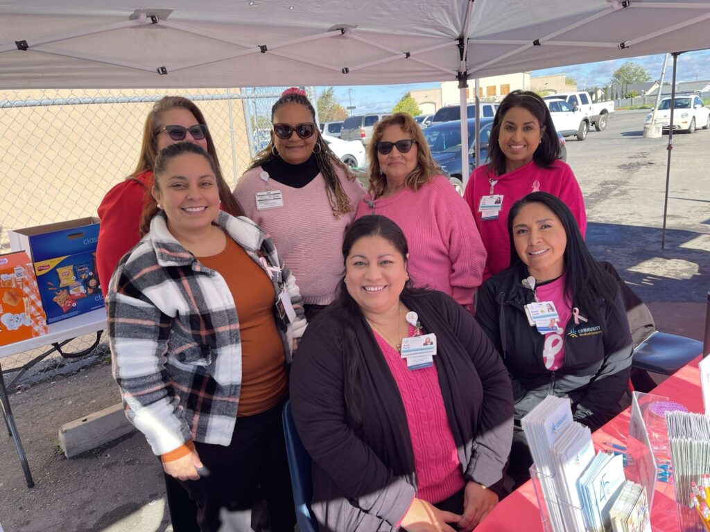 Group of woman all wearing pink at booth