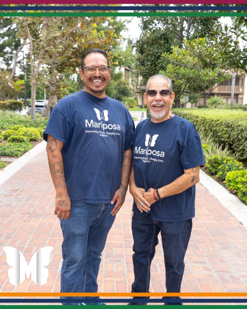 Two people wearing Mariposa Women and Family Center shirts