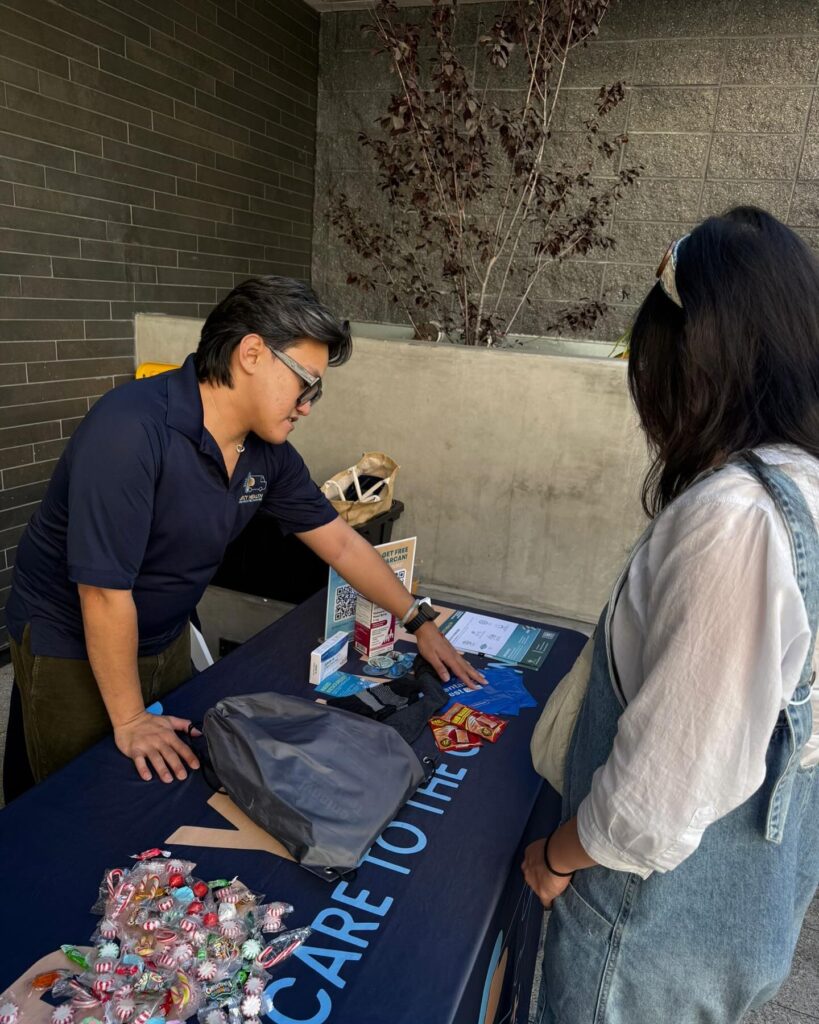 Mercy Health employee showing pamphlet to woman