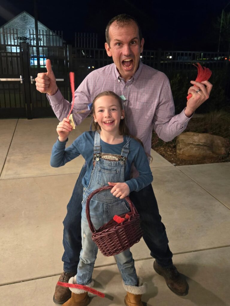Man making silly face with smiling daughter