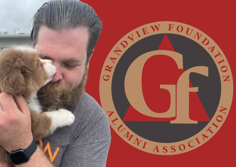 Man holding puppy alongside Grandview Foundation logo