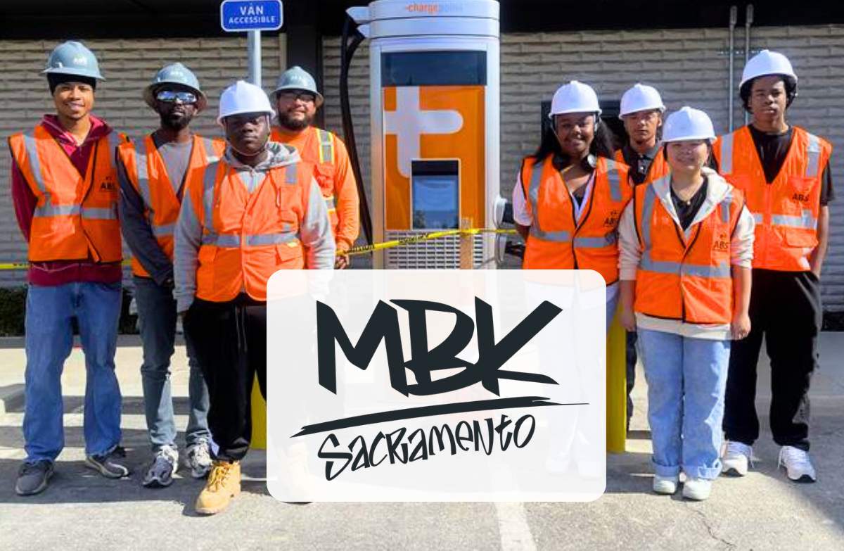 MBK Cohort 6 fellows stand by an electric vehicle charging station