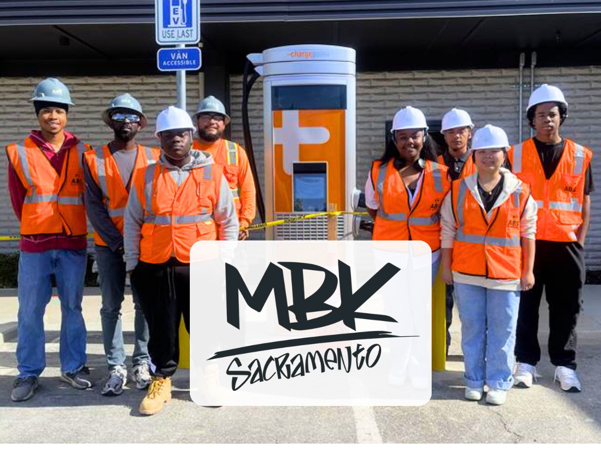 MBK Cohort 6 fellows stand by an electric vehicle charging station