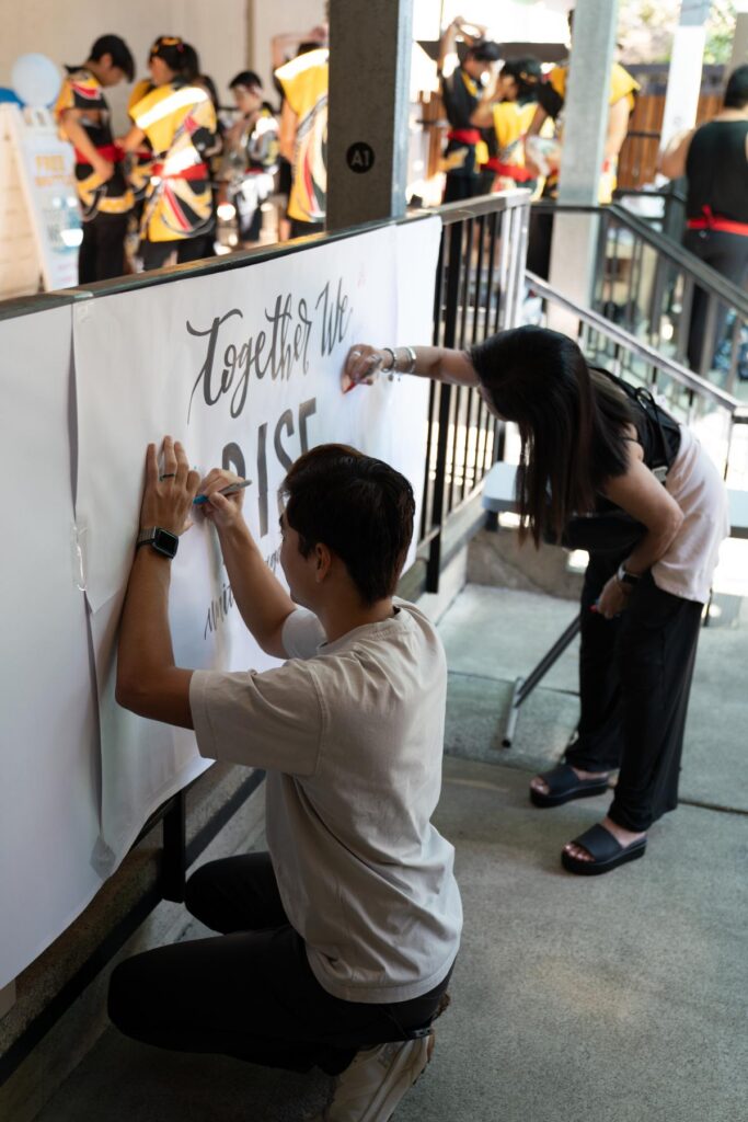 Asian American Liberation Network members making a sign