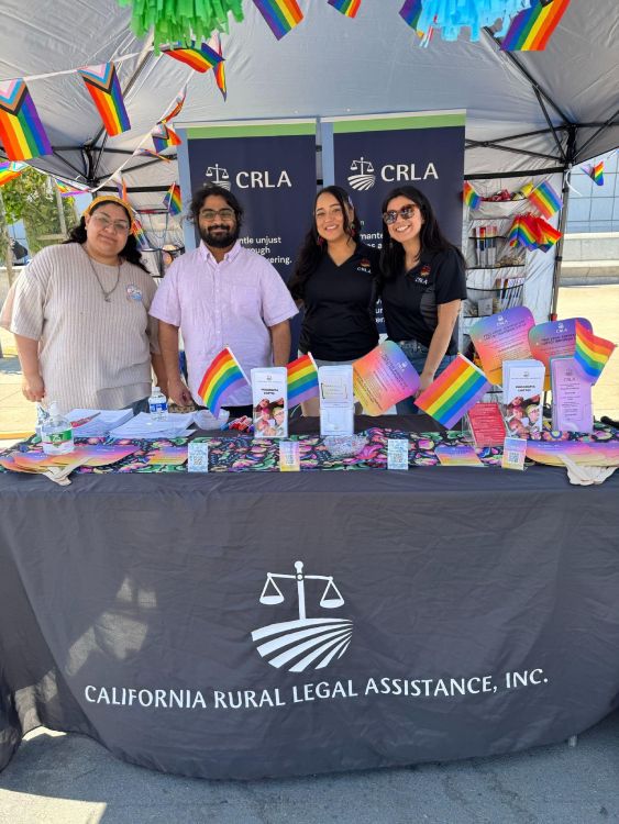 4 people at a California Rural Legal Assistance booth 