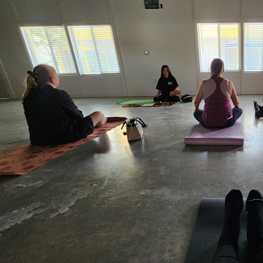 Small group of woman sitting at a yoga class