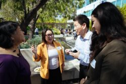 Kaying Hang pictured speaking with community partners